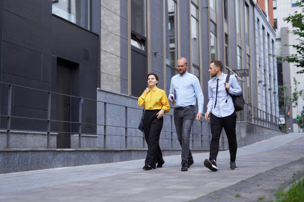 istock Business group of people going down the street discussing project 1371786347