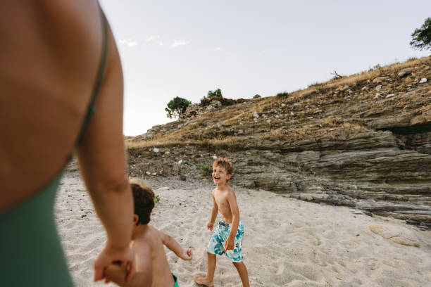 istock Mommy and her boys at the beach 1371786636