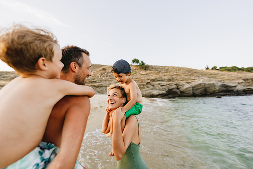 Photo of a smiling family by the sea