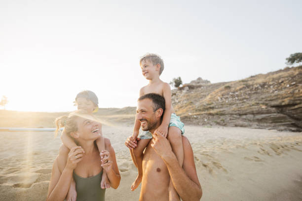 Its Easter on the beach. Grandparents and grandchildren are walking on beach wearing bunny ears.