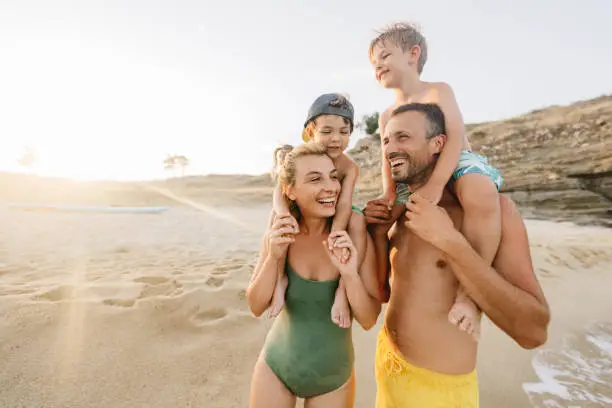 Photo of a smiling family at the beach