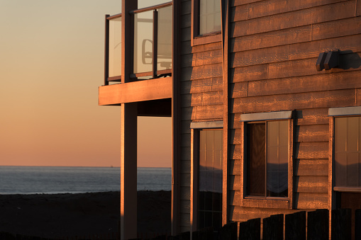 Sunset puts glowing highlights on walls of a resort building near Light State Park, Gray Harbor, Washington