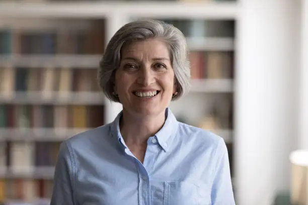 Photo of Portrait of happy middle aged businesswoman posing in office.