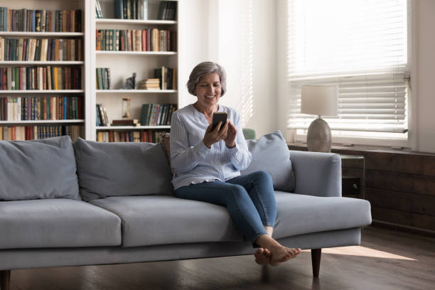 istock Happy middle aged 50s woman using smartphone apps. 1371790461