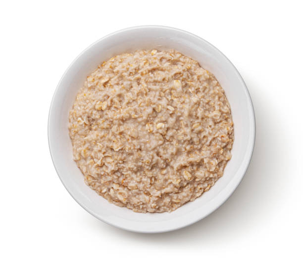 istock Bowl of oatmeal isolated on white background, top view 1371790657