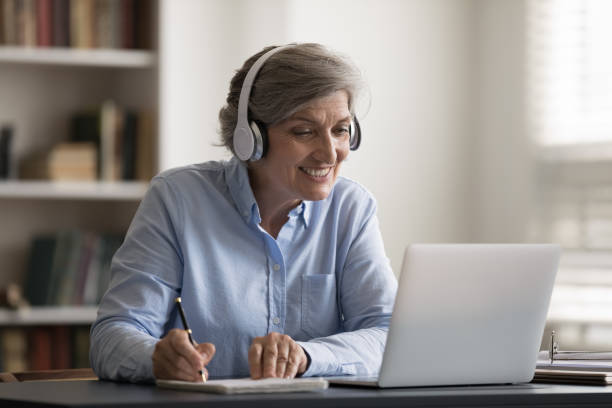 istock Happy middle aged woman studying on online lecture. 1371791917