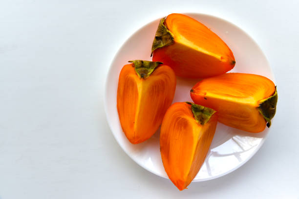 istock Diospyros persimmon slices on a white plate 1371794831