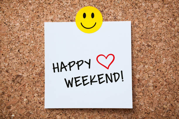 White Sticky Note With Happy Weekend And Red Push Pin On Cork Board stock photo