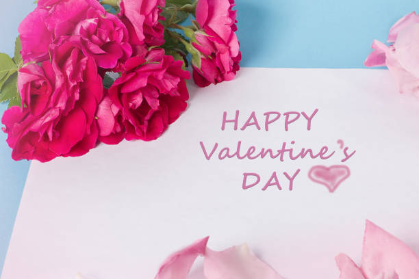 istock Pink roses with green leaves overhead view - flat ly 1371796101
