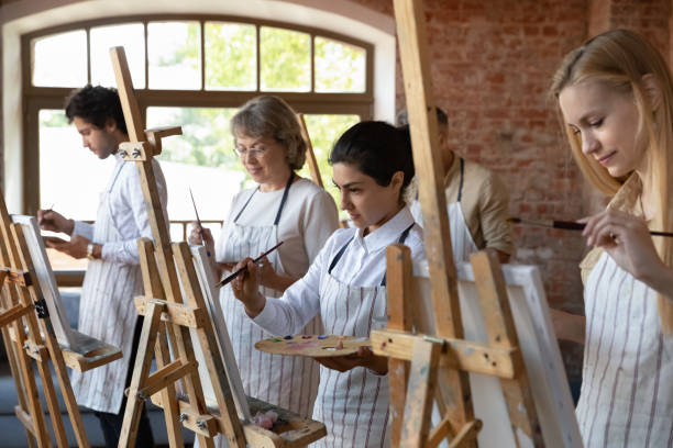 istock Happy focused diverse people drawing on canvas. 1371797932