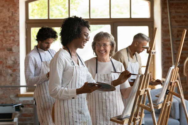 istock Happy multiracial people enjoying creative art class. 1371797944