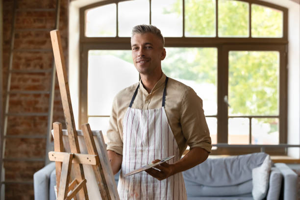 istock Portrait of handsome 40s man drawing on canvas. 1371797968