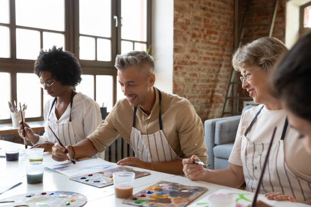 istock Happy handsome man enjoying drawing workshop with diverse people. 1371797988