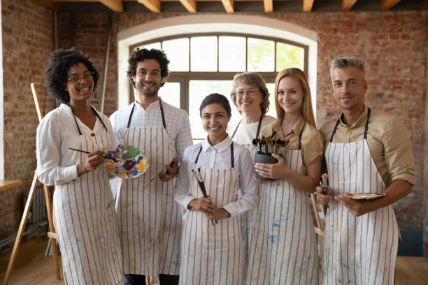 istock Portrait of smiling multiracial people posing after art master class. 1371797993