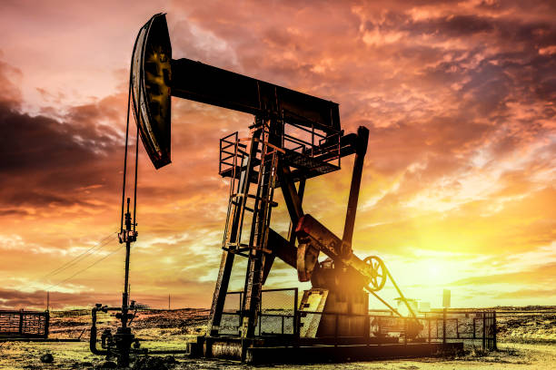 Oil pumpjack at sunset stock photo