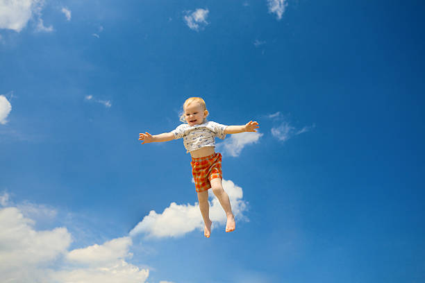 fly of a child in the sky stock photo