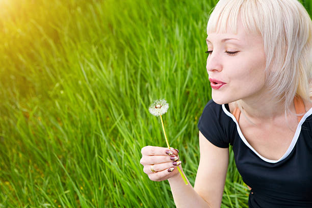 istock girl with dandelion 137180084