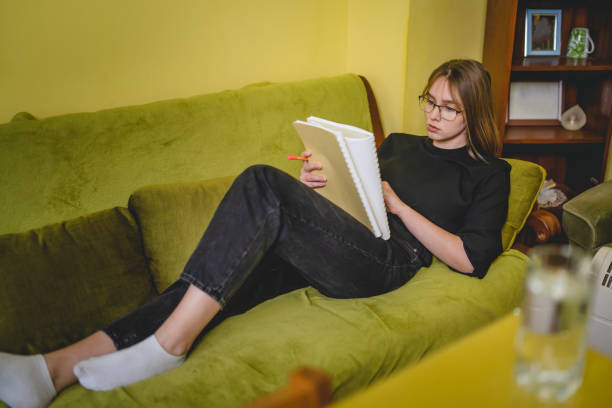 istock One young caucasian woman female student study while lying in her bed at home 1371800956