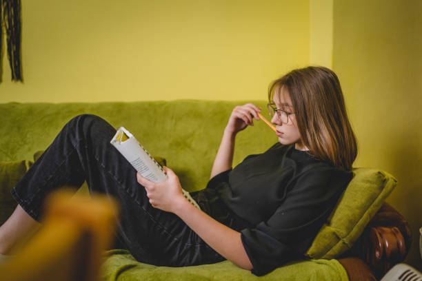 istock One young caucasian woman female student study while lying in her bed at home 1371800991