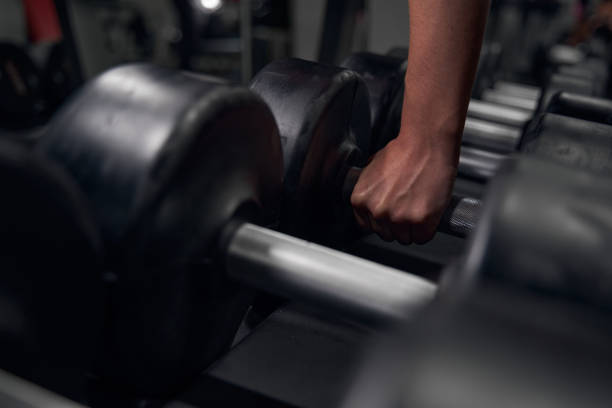 istock Focused photo on female hand that taking weights 1371802415