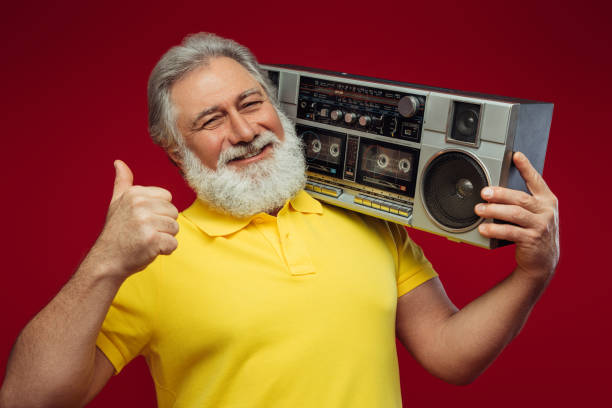 istock Old man holding with cassette boom box enjoying music 1371804601