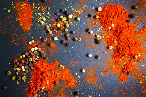spices turmeric, pepper in on a dark background