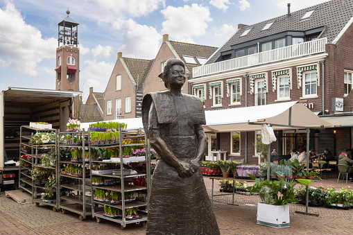 Spakenburg, Netherlands, February 19, 2022; Statue of a woman in traditional dress in the historic fishing village of Spakenburg.