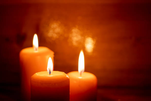 istock Burning candles on a wooden background. 1371808139