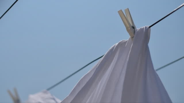 Drying bed sheets outdoor in hot summer air