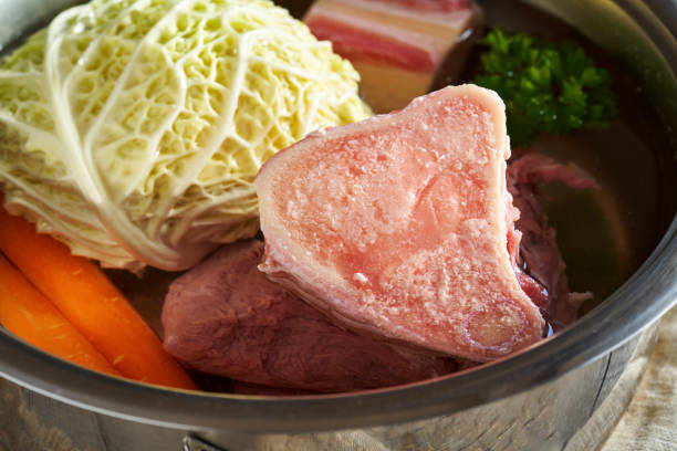 istock Ingredients to prepare beef bone broth or soup - marrow bones and fresh vegetables 1371810203