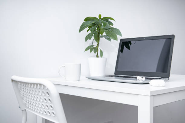 istock Laptop, white cup, wireless headphones on a white table. Workplace. 1371812192
