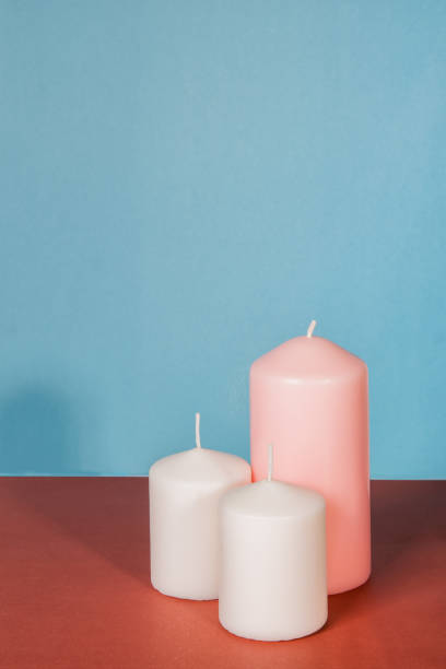 istock candles pink white on blue and brown background 1371815368