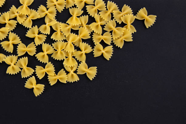 istock heap farfalle pasta on black background, top view 1371816906