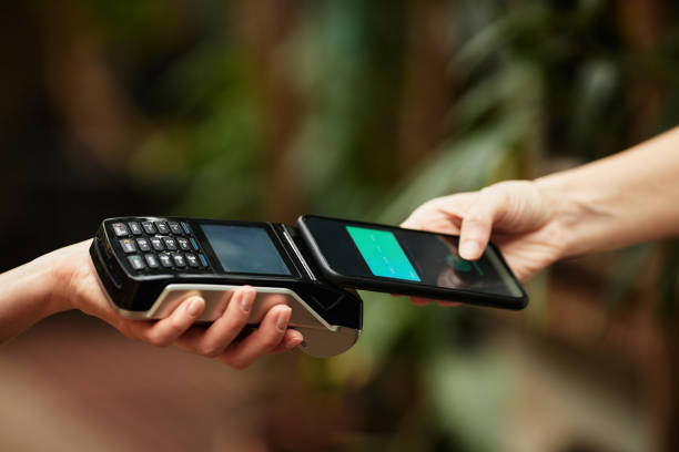 istock Shop assistant holding payment terminal during contactless financial operation 1371820430