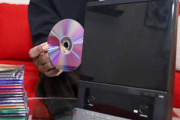 A black African-American man holding a audio CD in his hand