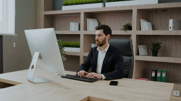 istock Handsome mature businessman using computer working online sitting in office. typing on the keyboard at workplace 1371822133