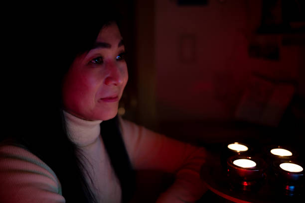 Woman working and relaxing at night in home, with multi-colored lighting equipments, featuring innovation in digital area.