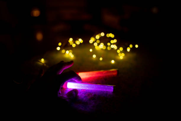 Woman working and relaxing at night in home, with multi-colored lighting equipments, featuring innovation in digital area.
