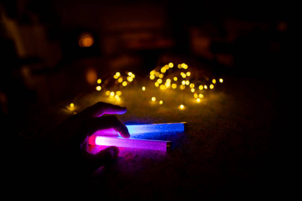 Woman working and relaxing at night in home, with multi-colored lighting equipments, featuring innovation in digital area.