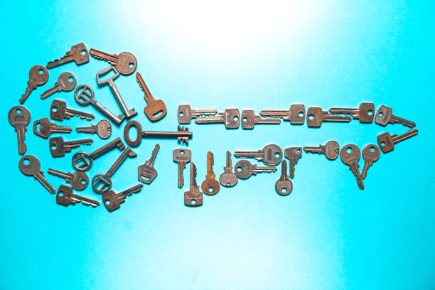 A display of a key made of many keys on a blue background. Solution, secret, secure or locked concept