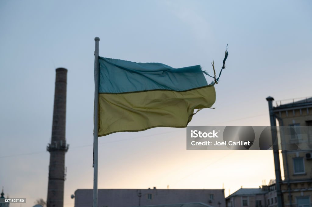 Ukrainian flag in Kyiv battered by the elements A weathered Ukrainian flag flies in the Podil district of Kyiv, Ukraine Ukraine Stock Photo