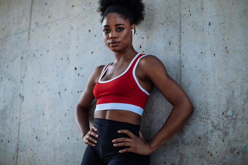 Portrait shot of a young athletic African American woman standing outdoors after her workout