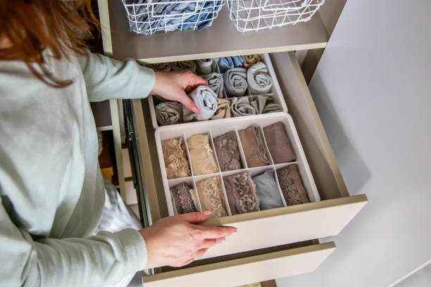 istock Top view female hands holding organizer drawer divider with socks storage Marie Kondo's method 1371837131