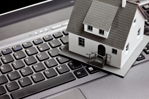 Little house upon a laptop keyboard 
