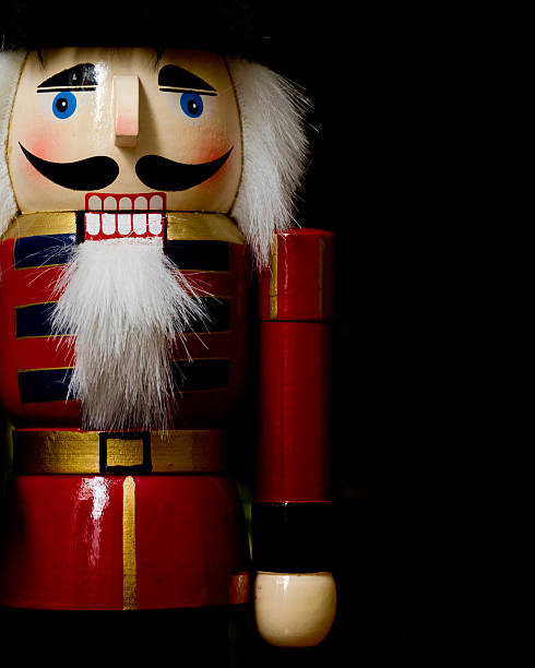 Detailed view of nutcracker, on black background  Nutcracker toy solider with black copyspace nutcracker photos stock pictures, royalty-free photos & images