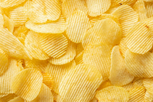 istock crispy golden potato chips snack texture background 1371841774