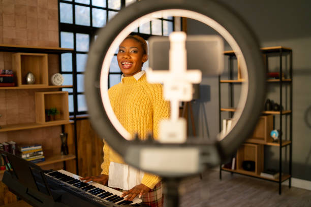 istock Pianist practising on a keyboard and recording on a cellphone 1371842128