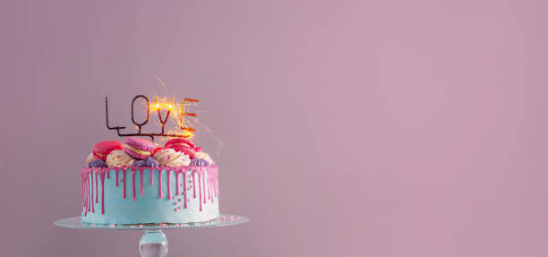 istock cake with pink and blue decor and burning sparkler with text love 1371842237