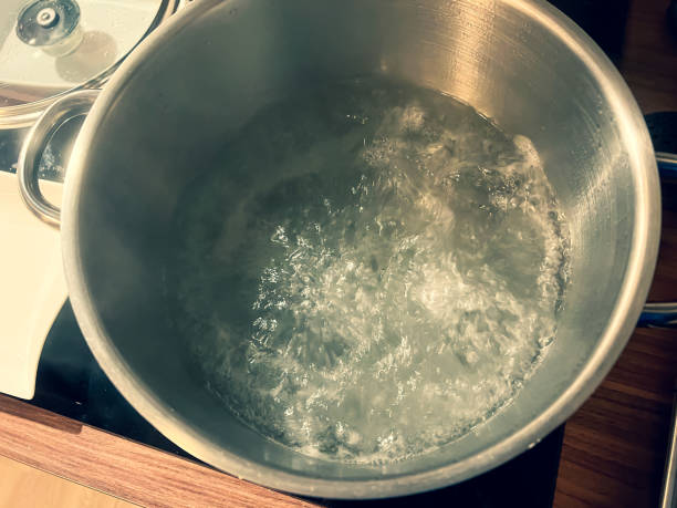 istock Boiling water in a large iron pot. 1371848159