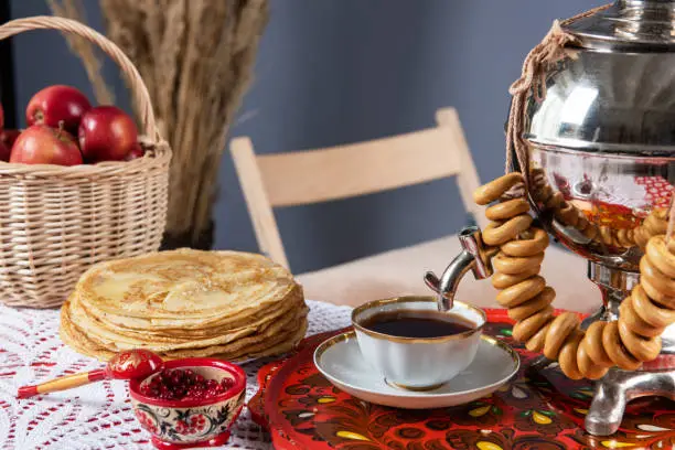Russian pancakes blini with samovar tea cup and drying on the table. Shrovetide Maslenitsa festival concept.